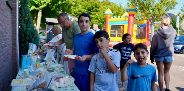 kinderen uit de Steve Bikostraat genieten van het buurtfeestpakket