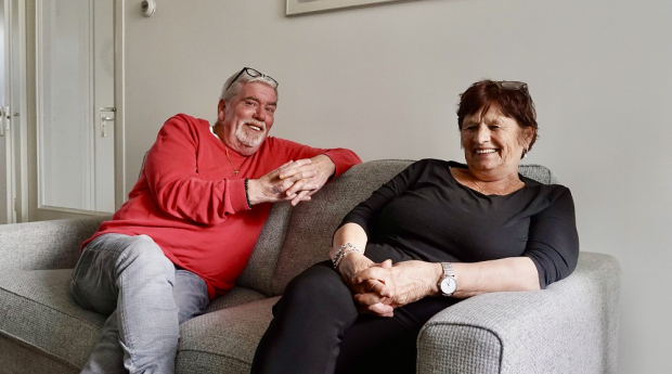 Tineke en Paul op de bank in hun nieuwe woning in Loosduinen